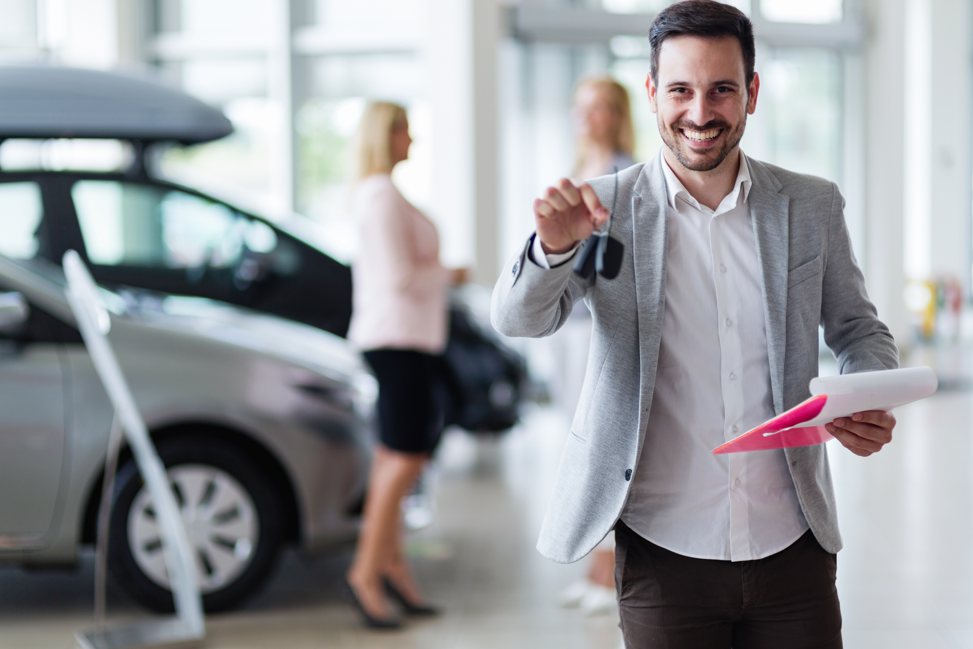 Handsome Salesman At Car Dealership Selling Vehichles All Consuming